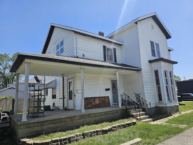 58 E 5th St, Peru, IN 46970 - view of front of house with covered porch and a chimney