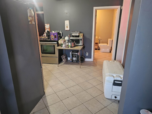 58 E 5th St, Peru, IN 46970 - kitchen with appliances with stainless steel finishes and light tile patterned floors