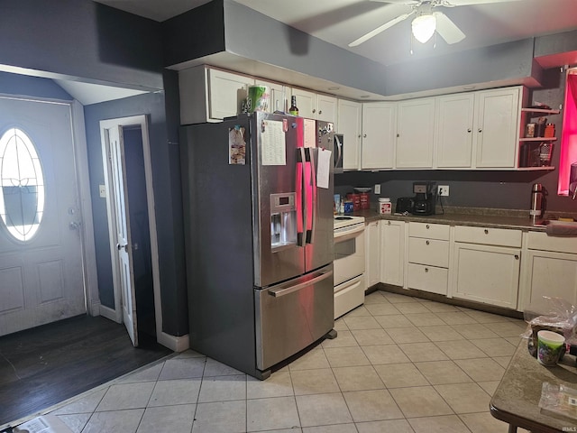 58 E 5th St, Peru, IN 46970 - kitchen featuring stainless steel fridge with ice dispenser, white electric stove, light tile patterned floors, white cabinetry, and a ceiling fan