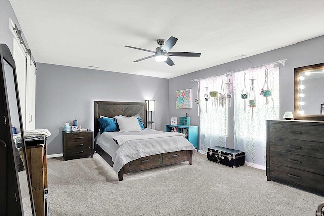7228 W Mustang Dr, Ellettsville, IN 47429 - bedroom featuring carpet, a barn door, baseboards, and ceiling fan
