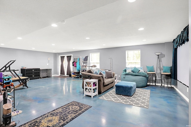 7228 W Mustang Dr, Ellettsville, IN 47429 - living room featuring finished concrete flooring, recessed lighting, and baseboards