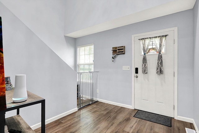 7228 W Mustang Dr, Ellettsville, IN 47429 - foyer entrance with wood finished floors, plenty of natural light, and baseboards