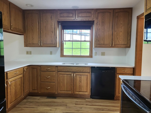 104 Leatherwood Creek Ests, Bedford, IN 47421 - kitchen featuring dishwasher, brown cabinets, light countertops, light wood finished floors, and a sink