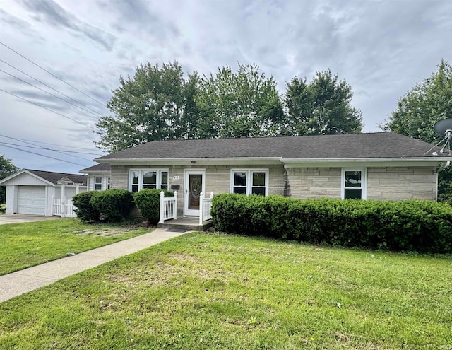 815 3rd St, Huntingburg, IN 47542 - single story home with a front lawn, stone siding, a garage, and a shingled roof