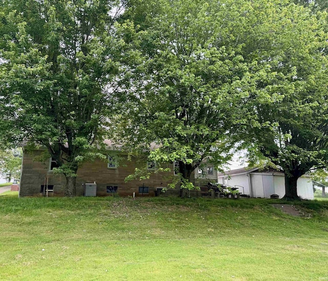815 3rd St, Huntingburg, IN 47542 - view of green lawn featuring central air condition unit