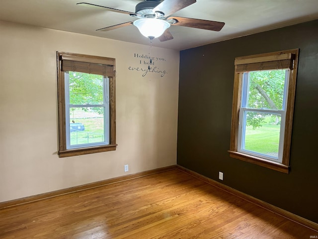 815 3rd St, Huntingburg, IN 47542 - empty room with light wood finished floors, ceiling fan, and baseboards