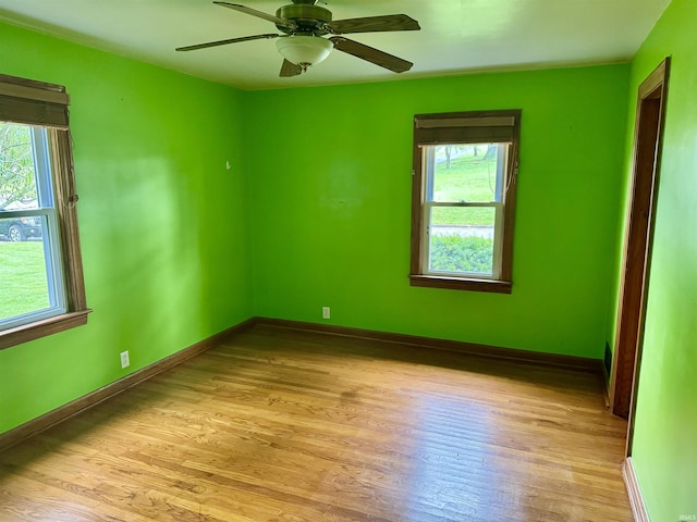 815 3rd St, Huntingburg, IN 47542 - empty room featuring plenty of natural light, light wood finished floors, and baseboards