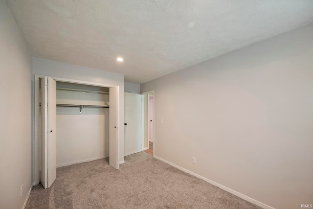 10 Cavalry Ct, West Lafayette, IN 47906 - unfurnished bedroom with light carpet, a closet, baseboards, and recessed lighting