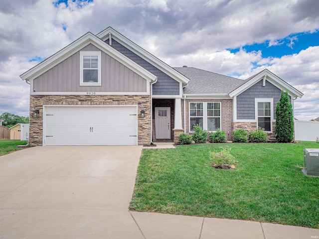 9920 Blyth Dr, Evansville, IN 47725 - craftsman-style house featuring stone siding, driveway, and a front yard