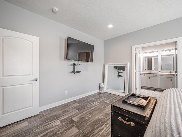 9920 Blyth Dr, Evansville, IN 47725 - unfurnished bedroom with baseboards, wood finished floors, connected bathroom, a textured ceiling, and recessed lighting