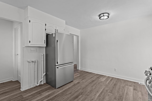 112 W Monroe St, Alexandria, IN 46001 - kitchen featuring stainless steel appliances, white cabinetry, wood finished floors, and baseboards