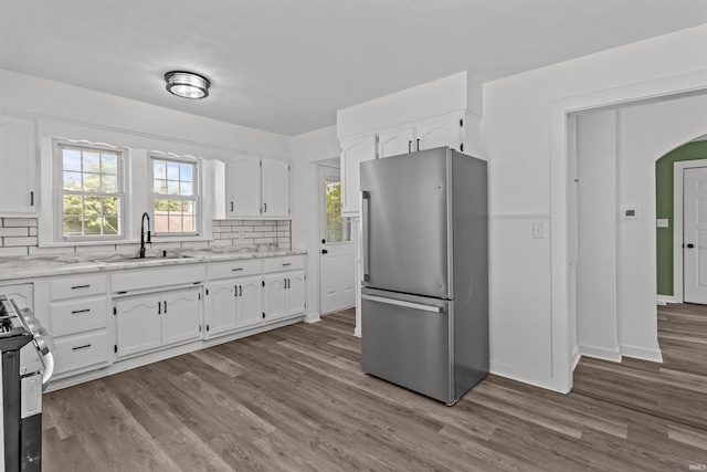 112 W Monroe St, Alexandria, IN 46001 - kitchen with freestanding refrigerator, a sink, stove, and white cabinets