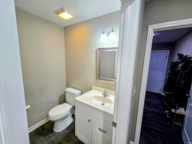 405 Ariel Dr, Kokomo, IN 46901 - bathroom featuring wood finished floors, vanity, toilet, and baseboards