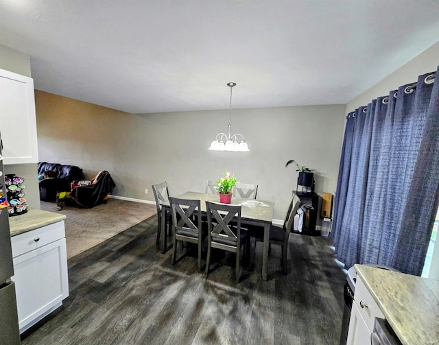 405 Ariel Dr, Kokomo, IN 46901 - dining room featuring dark wood-type flooring, baseboards, and a chandelier