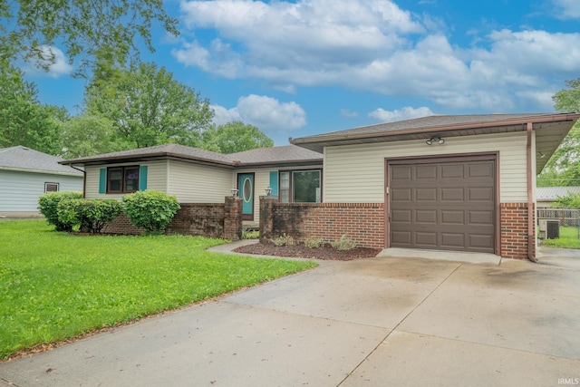 2305 S Dixon Rd, Kokomo, IN 46902 - view of front of property featuring brick siding, concrete driveway, a garage, a front lawn, and central AC