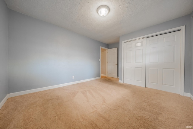 2305 S Dixon Rd, Kokomo, IN 46902 - unfurnished bedroom with carpet floors, a textured ceiling, baseboards, and a closet