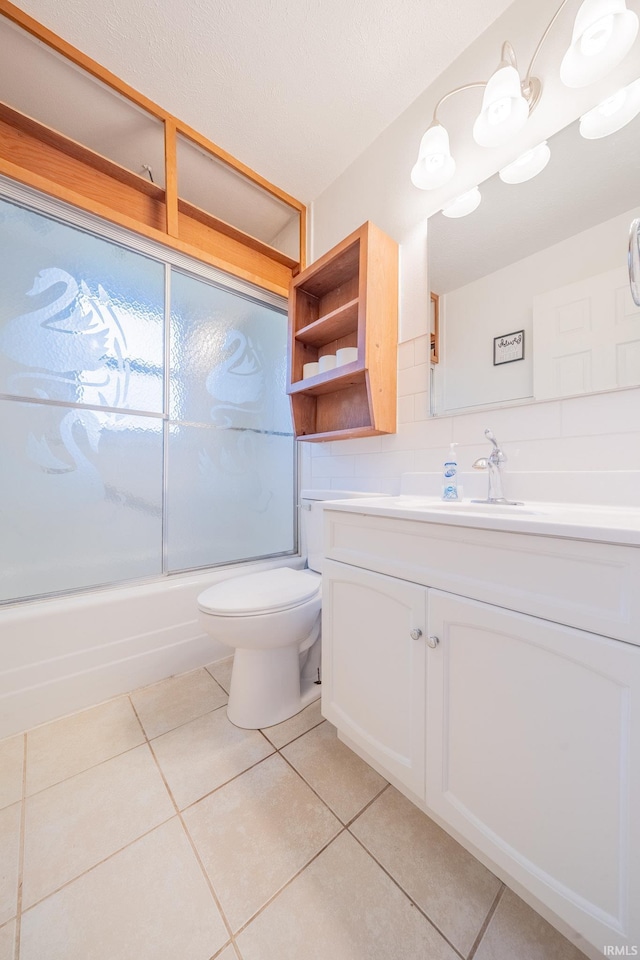 2305 S Dixon Rd, Kokomo, IN 46902 - bathroom with vanity, tile patterned flooring, toilet, and bath / shower combo with glass door