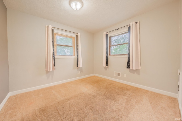 2305 S Dixon Rd, Kokomo, IN 46902 - spare room featuring carpet floors, baseboards, and a textured ceiling