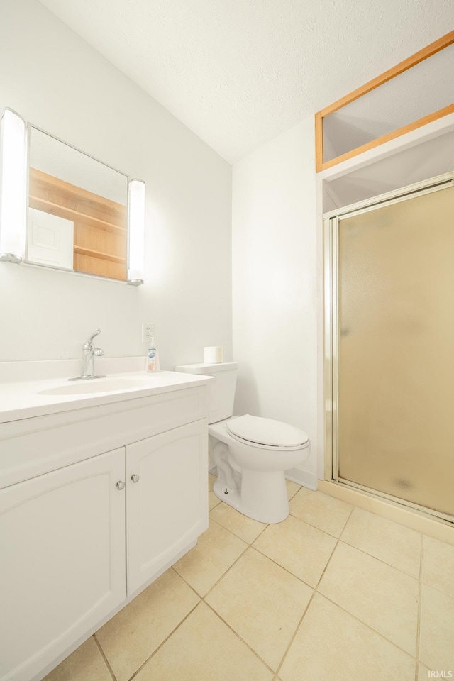 2305 S Dixon Rd, Kokomo, IN 46902 - full bathroom featuring vanity, a stall shower, tile patterned flooring, toilet, and a textured ceiling