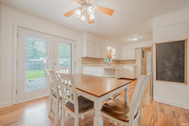 2305 S Dixon Rd, Kokomo, IN 46902 - dining area featuring light wood finished floors, baseboards, a ceiling fan, and french doors