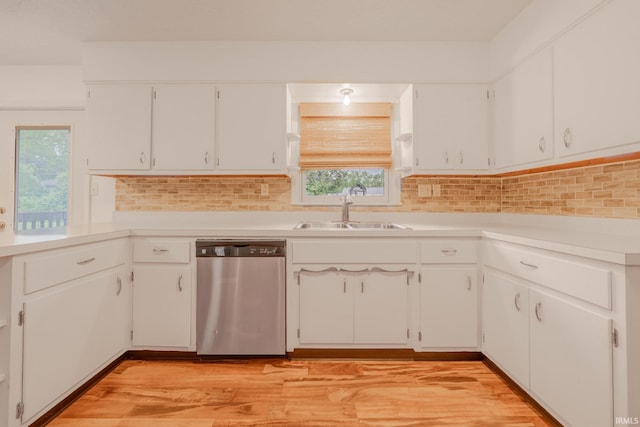 2305 S Dixon Rd, Kokomo, IN 46902 - kitchen with stainless steel dishwasher, a sink, white cabinetry, light wood finished floors, and light countertops