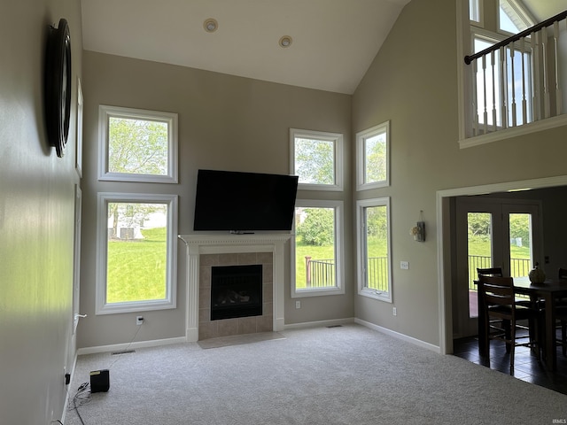 7019 Tree Top Trl, Fort Wayne, IN 46845 - unfurnished living room featuring high vaulted ceiling, baseboards, carpet, and plenty of natural light