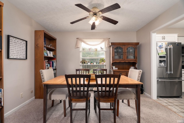 5203 Goldersgreen Dr, Lafayette, IN 47905 - dining room featuring ceiling fan, a textured ceiling, baseboards, and light carpet