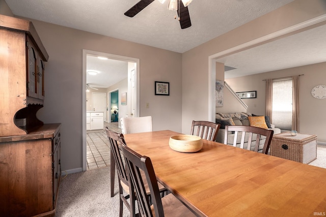 5203 Goldersgreen Dr, Lafayette, IN 47905 - dining room with ceiling fan, light colored carpet, baseboards, and a textured ceiling