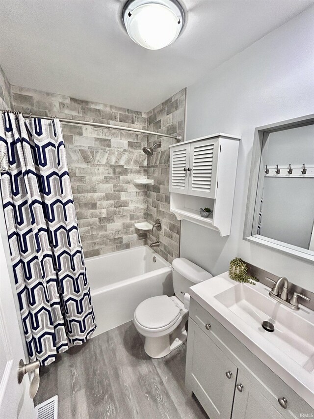 305 N Maude Dr, Rossville, IN 46065 - bathroom with wood finished floors, toilet, vanity, and shower / bath combination with curtain