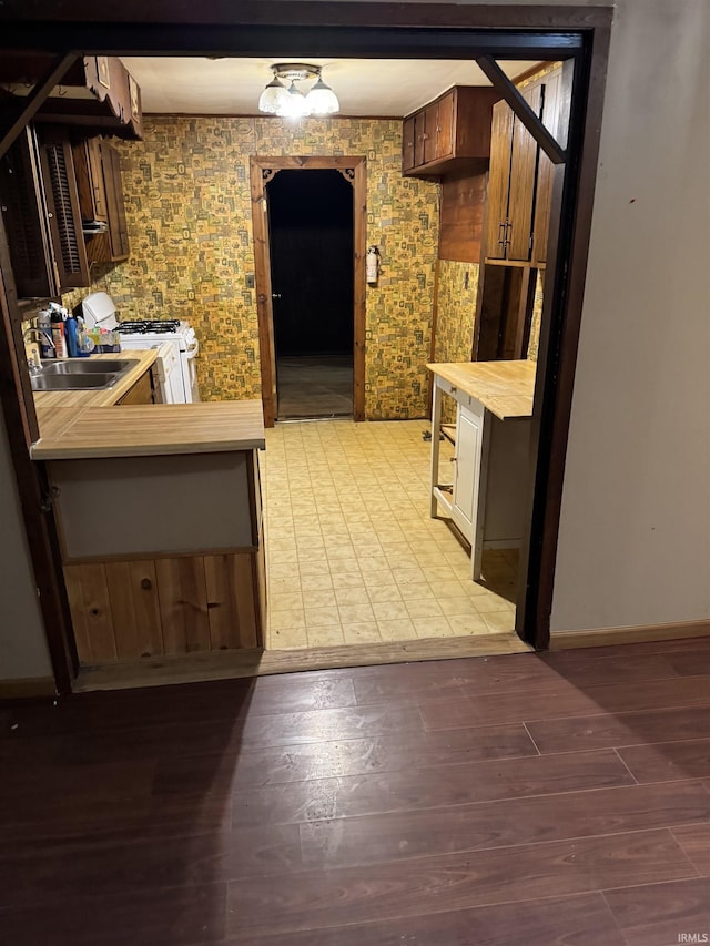10522 Saint Wendel Rd, Evansville, IN 47720 - kitchen featuring wooden counters, white gas range oven, a sink, light wood-style flooring, and baseboards