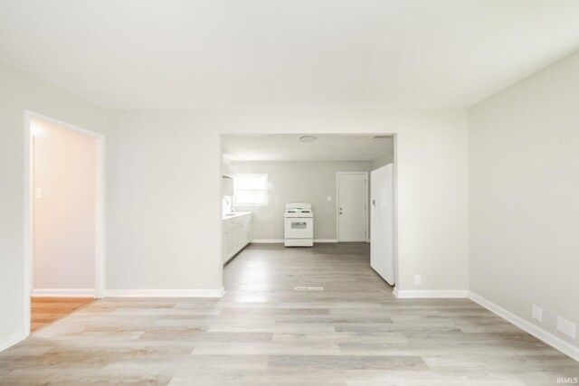 2726 Apache Dr, Anderson, IN 46012 - unfurnished room featuring light wood finished floors, baseboards, and a sink