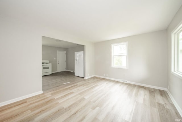 2726 Apache Dr, Anderson, IN 46012 - unfurnished living room with healthy amount of natural light, light wood-style flooring, and baseboards