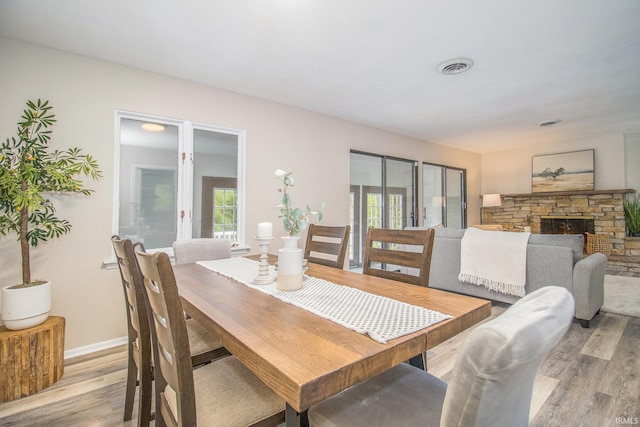 17330 Mcerlain St, South Bend, IN 46635 - dining area featuring light wood-style flooring, a fireplace, baseboards, and french doors