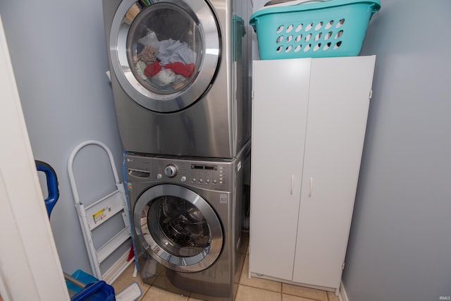 12908 Mattison Ct, Evansville, IN 47725 - laundry room with stacked washing machine and dryer and light tile patterned floors