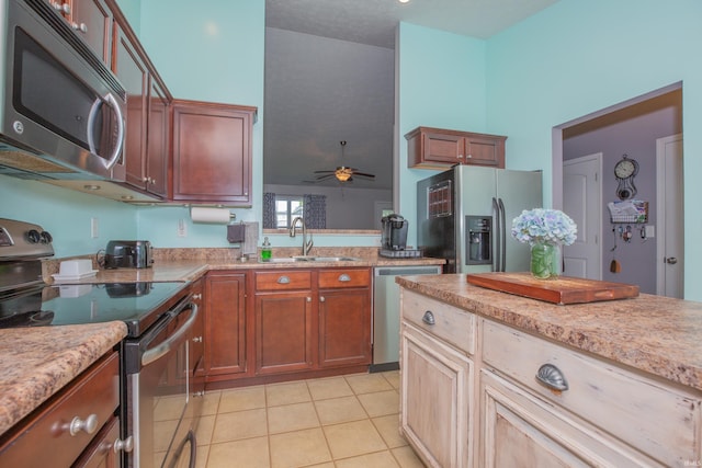 12908 Mattison Ct, Evansville, IN 47725 - kitchen featuring appliances with stainless steel finishes, a sink, a ceiling fan, light tile patterned flooring, and light stone counters