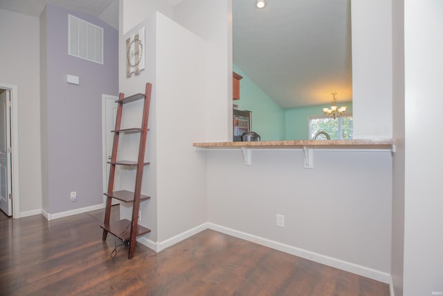12908 Mattison Ct, Evansville, IN 47725 - interior space with a chandelier, dark wood-type flooring, vaulted ceiling, and baseboards