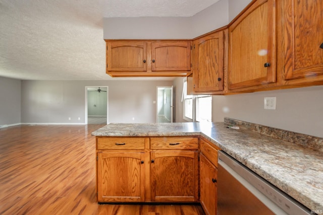 6863 W Jennifer Ct, Greenfield, IN 46140 - kitchen with dishwasher, a peninsula, open floor plan, wood finished floors, and a textured ceiling