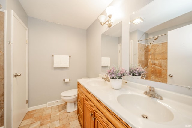 6863 W Jennifer Ct, Greenfield, IN 46140 - full bathroom featuring double vanity, toilet, a shower, and baseboards