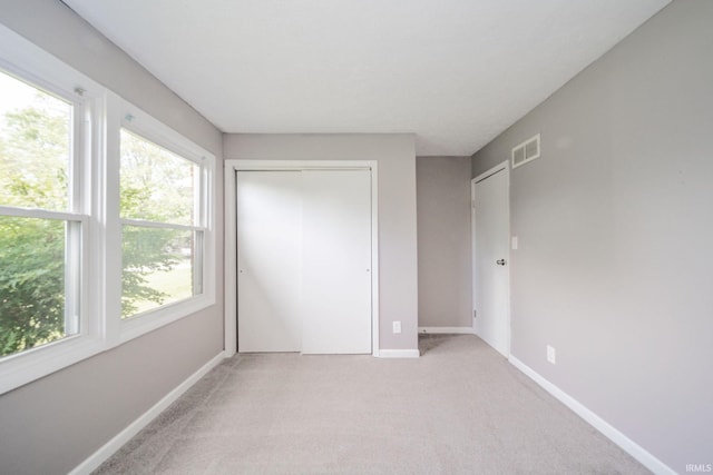 6863 W Jennifer Ct, Greenfield, IN 46140 - unfurnished bedroom with light colored carpet, baseboards, and a closet