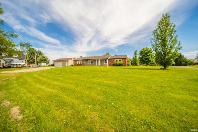 6863 W Jennifer Ct, Greenfield, IN 46140 - view of grassy yard with driveway and an attached garage