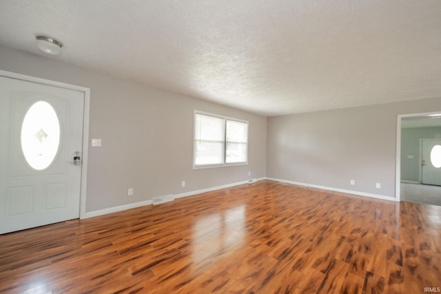 6863 W Jennifer Ct, Greenfield, IN 46140 - entrance foyer with wood finished floors, a textured ceiling, and baseboards