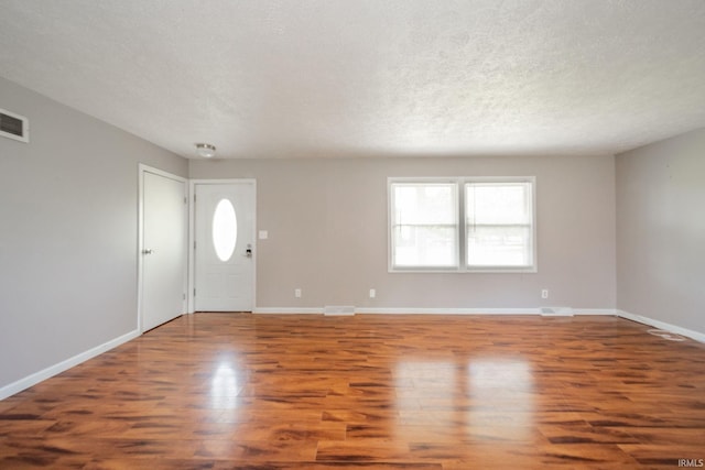 6863 W Jennifer Ct, Greenfield, IN 46140 - entrance foyer with wood finished floors, baseboards, and a textured ceiling