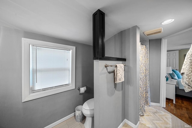 1905 Inglewood Pl, South Bend, IN 46616 - bathroom with baseboards, toilet, and a shower with shower curtain