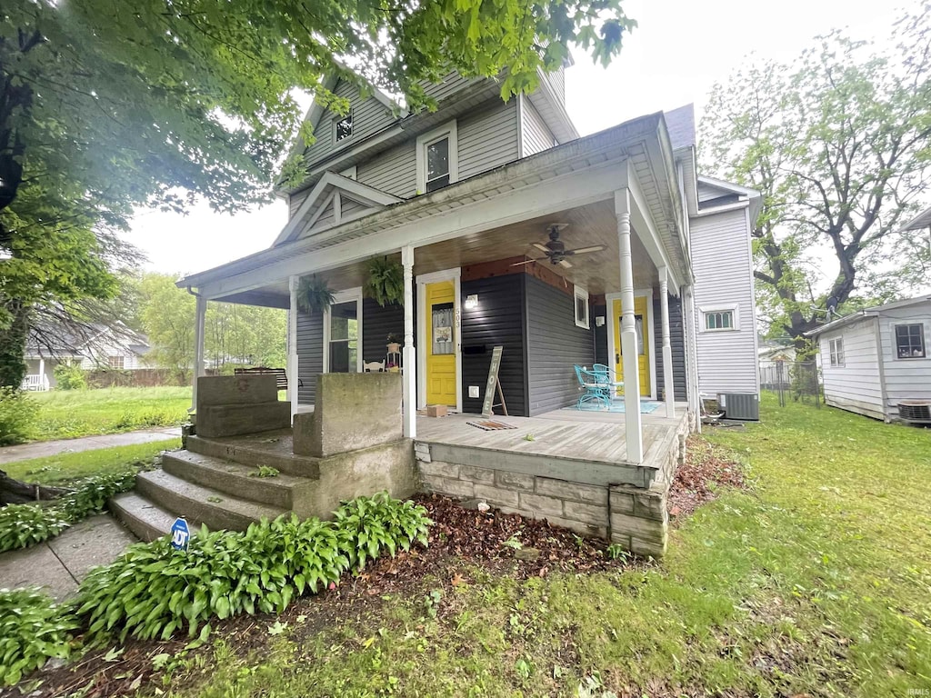 503 S Washington St, Kokomo, IN 46901 - view of front facade featuring a porch, a ceiling fan, a front yard, and central AC unit