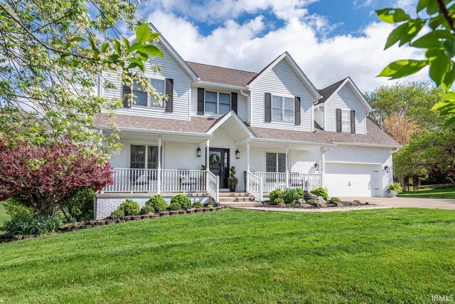 2630 E Clarkway Dr, Bloomington, IN 47401 - view of front of property with a porch, roof with shingles, driveway, a front yard, and an attached garage