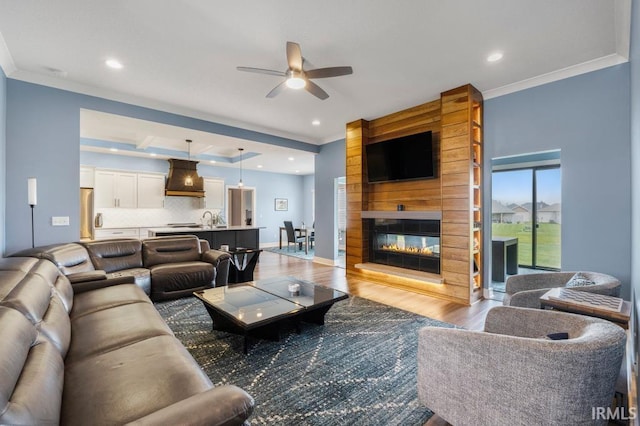 2696 Maraquita Ct, Fort Wayne, IN 46845 - living area featuring ceiling fan, wood finished floors, ornamental molding, recessed lighting, and a large fireplace