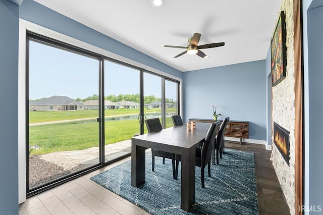 2696 Maraquita Ct, Fort Wayne, IN 46845 - dining space featuring a ceiling fan, a residential view, a water view, a fireplace, and baseboards