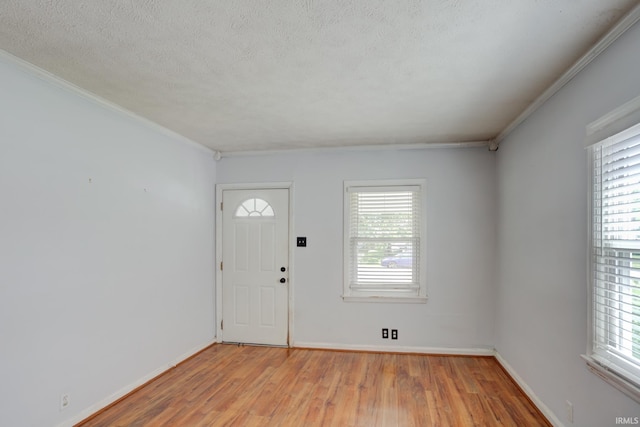 1521 Monroe Ave, Evansville, IN 47714 - foyer featuring light wood-style flooring, healthy amount of natural light, crown molding, baseboards, and a textured ceiling