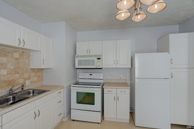 1521 Monroe Ave, Evansville, IN 47714 - kitchen with white appliances, a sink, decorative backsplash, white cabinets, and light countertops