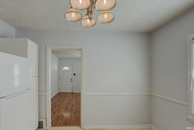 1521 Monroe Ave, Evansville, IN 47714 - unfurnished dining area featuring wood finished floors and a chandelier
